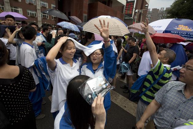 Students file out after the end of college entrance exams in Beijing, Monday, June 8, 2015. Nearly all Chinese high school graduates must take the test, which more than 9 million students started on Sunday. The scores are the key criterion for which tier of university they can enter. (AP Photo/Ng Han Guan)