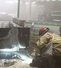 A firefighter inspects the site of a fire at Lotte Mart inside the second Lotte World in southern Seoul, Monday. (Yonhap)