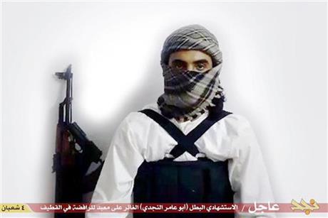 FILE - This file image taken from a militant website associated with Islamic State extremists, posted Saturday, May 23, 2015, purports to show a suicide bomber, with the Arabic bar below reading: "Urgent: The heroic martyr Abu Amer al-Najdi, the attacker of the (Shiite) temple in Qatif", which the Islamic State group's radio station claimed responsibility for. Al-Bayan, the Islamic State radio targeting potential European recruits, touts recent triumphs in the campaign to carve out a Caliphate with contrast between the smooth, Western-style production and the extremist content showing how far the hardcore Islamic propaganda machine has come since its beginnings in 2012. (Militant photo via AP, FILE)