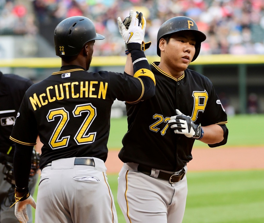 Pittsburgh Pirates' Kang Jung Ho (27) is greeted by Andrew McCutchen (22) after hitting a two-run home run against the Chicago White Sox during the first inning of a baseball game, Wednesday, June 17, 2015, in Chicago. (AP Photo/David Banks)
