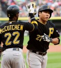 Pittsburgh Pirates' Kang Jung Ho (27) is greeted by Andrew McCutchen (22) after hitting a two-run home run against the Chicago White Sox during the first inning of a baseball game, Wednesday, June 17, 2015, in Chicago. (AP Photo/David Banks)