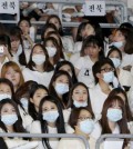 Nurses wear masks as a precaution against the MERS virus as they attend an International Conference of Nurses in Seoul, South Korea, Friday, June 19, 2015. The WHO head has praised beleaguered South Korean officials and exhausted health workers, saying their efforts to contain a deadly MERS virus outbreak have put the country on good footing and lowered the public risk. (Yonhap)