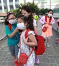 South Korean elementary school students wear masks as a precaution against the MERS, Middle East Respiratory Syndrome, virus as they go to school in Seoul, South Korea, Wednesday, June 10, 2015. South Korea believes its MERS virus outbreak may have peaked, and experts say the next several days will be critical to determining whether the government's belated efforts have successfully stymied a disease that has killed seven people and infected nearly 100 in the country.(AP Photo/Ahn Young-joon)