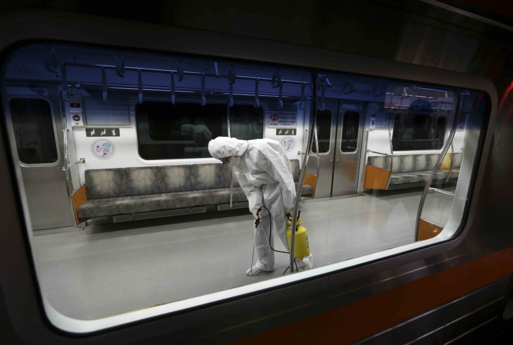A worker wearing protective gear sprays antiseptic solution in a subway car amid rising public concerns over the spread of MERS, Middle East Respiratory Syndrome, virus at the subway car depot in Goyang, South Korea, Tuesday, June 9, 2015. South Korea believes its MERS virus outbreak may have peaked, and experts say the next several days will be critical to determining whether the government's belated efforts have successfully stymied a disease that has killed seven people and infected nearly 100 in the country. (AP Photo/Lee Jin-man)