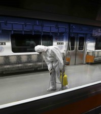 A worker wearing protective gear sprays antiseptic solution in a subway car amid rising public concerns over the spread of MERS, Middle East Respiratory Syndrome, virus at the subway car depot in Goyang, South Korea, Tuesday, June 9, 2015. South Korea believes its MERS virus outbreak may have peaked, and experts say the next several days will be critical to determining whether the government's belated efforts have successfully stymied a disease that has killed seven people and infected nearly 100 in the country. (AP Photo/Lee Jin-man)