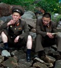 A North Korean soldier smokes a cigarette as he takes a rest with his comrade along the river bank of the North Korean town of Sinuiju, opposite the Chinese border city of Dandong Friday, May 24, 2013. A top North Korean envoy delivered a letter from leader Kim Jong Un to Chinese President Xi Jinping on Friday and told him Pyongyang would take steps to rejoin stalled six-nation nuclear disarmament talks, in an apparent victory for Beijing's efforts to coax its unruly ally into lowering tensions. (AP Photo)