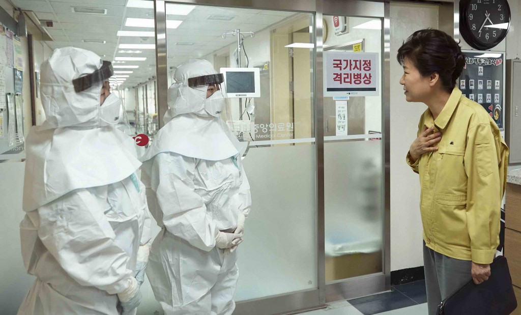 South Korean President Park Geun-hye, right, talks with health care workers wearing protective gears as she visits the National Medical Center housing MERS, Middle East Respiratory Syndrome, patients in Seoul, South Korea, June 5, 2015. Sales of surgical masks surge amid fears of the deadly, poorly understood virus. Airlines announce "intensified sanitizing operations." More than 1,100 schools close and 1,600 people - and 17 camels in zoos - are quarantined. The current frenzy in South Korea over MERS brings to mind the other menacing diseases to hit Asia over the last decade - SARS, which killed hundreds, and bird flu. (Yonhap)