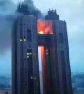 In this photo, exclusively obtained and released on June 12, 2015 by local radio station BBS, black smoke and flames billow from a bridge between the 43rd floors of Koryo Hotel in the North Korean capital of Pyongyang on the previous day. The fire had broken out at the hotel frequented by foreigners, without any information being provided on casualties or property damage, reports said on June 12, 2015. The fire appears to have been extinguished, according to The Associated Press. (Yonhap)