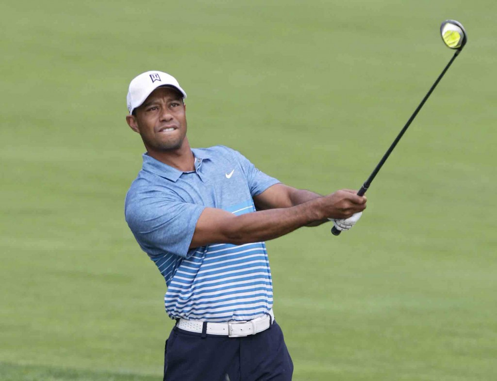 Tiger Woods watches his approach shot on the 18th hole during a practice round for The Memorial golf tournament, Wednesday, June 3, 2015, in Dublin, Ohio. (AP Photo/Jay LaPrete)