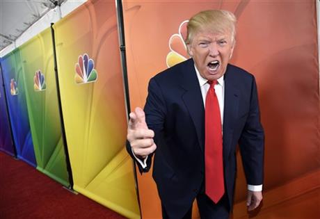 FILE - In this Jan. 16, 2015 file photo, Donald Trump, host of the television series "The Celebrity Apprentice," mugs for photographers at the NBC 2015 Winter TCA Press Tour in Pasadena, Calif. NBC on Monday, June 29, 2015 said that it is ending its business relationship with Trump, now a Republican presidential candidate, because of comments he made about immigrants during the announcement of his campaign. (Photo by Chris Pizzello/Invision/AP, File)