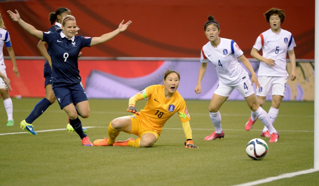 France's Eugenie Le Sommer, left, celebrates a goal by teammate Marie-Laure Delie, behind Le Sommer, past South Korea keeper Kim Jungmi (18) as South Korea's Shim Seoyeon (4) and Kim Doyeon (5) look on during first half FIFA Women's World Cup soccer action Sunday, June 21, 2015, in Montreal, Canada. (Paul Chiasson/The Canadian Press via AP) 