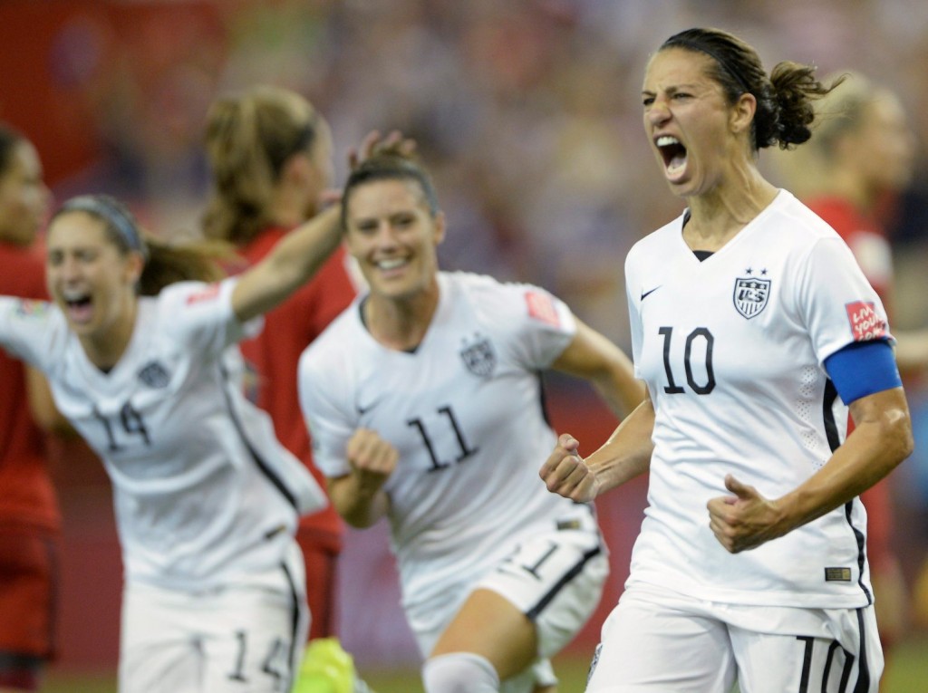 United States' Carli Lloyd (10) celebrates with teammates Ali Krieger (11) and Morgan Brian after scoring on a penalty kick against Germany during the second half of a semifinal in the Women's World Cup soccer tournament, Tuesday, June 30, 2015, in Montreal, Canada. (Ryan Remiorz/The Canadian Press via AP)