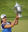 South Korea's In Gee Chun holds up the championship trophy after winning the U.S. Women's Open golf tournament at Lancaster Country Club, Sunday, July 12, 2015 in Lancaster, Pa. Chun won by one stroke over second place finisher Amy Yang.(AP Photo/Gene J. Puskar)