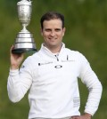 United States’ Zach Johnson poses with the trophy after winning a playoff after the final round at the British Open Golf Championship at the Old Course, St. Andrews, Scotland, Monday, July 20, 2015. (AP Photo/Peter Morrison)