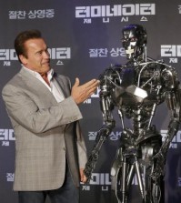 Actor Arnold Schwarzenegger stands with a model of a "Terminator" from the new film "Terminator Genisys" during a press conference at the Ritz Carlton hotel in Seoul, South Korea, Thursday, July 2, 2015. (AP Photo/Ahn Young-joon)