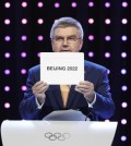 President of the International Olympic Committee (IOC) Thomas Bach opens the envelope announcing that Beijing has won the bid to host the 2022 Winter Olympic Games at the 128th International Olympic Committee session in Kuala Lumpur, Malaysia, Friday, July 31, 2015. Almaty and Beijing competed for the right to host the 2022 Winter Olympic Games. (AP Photo/Joshua Paul)