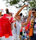 Chella Choi, front left, of South Korea, and her father and caddie Ji Yeon Choi, right, are doused by Mi Hyang Lee, also of South Korea, after winning the Marathon Classic golf tournament on the first playoff hole at Highland Meadows Golf Club in Sylvania, Ohio, Sunday, July 19, 2015. (AP Photo/Rick Osentoski)