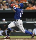 Texas Rangers' Shin-Soo Choo follows through on a solo home run against the Baltimore Orioles during the fifth inning of a baseball game Tuesday, June 30, 2015, in Baltimore. (AP Photo/Gail Burton)