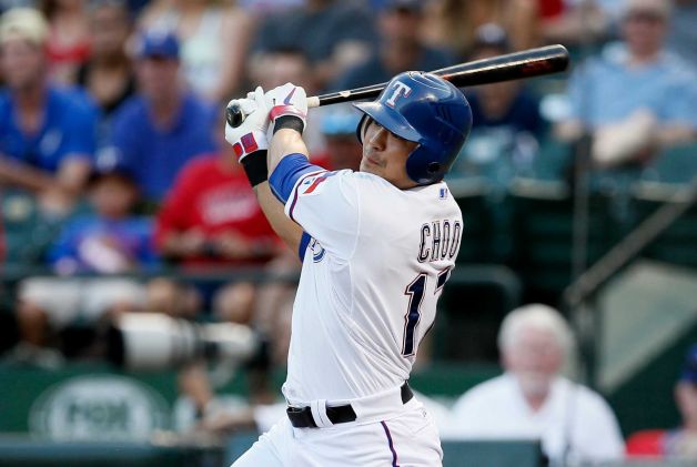 Texas Rangers' Shin-Soo Choo, of South Korea, follows through on a run-scoring single off a pitch from New York Yankees' Masahiro Tanaka in the second inning of a baseball game Wednesday, July 29, 2015, in Arlington, Texas. (AP Photo/Tony Gutierrez)
