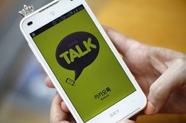 A woman opens Kakao Talk, a South Korean mobile messaging app with more than 60 million users, on her smartphone in Seoul, South Korea. A handful of smartphone apps that began as basic instant messaging services have amassed several hundred million users in Asia in just a couple of years, mounting a challenge to the popularity of online hangouts such as Facebook as they branch into games, e-commerce, celebrity news and other areas. (AP Photo/Hye Soo Nah)