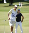 In this June 13, 2015, file photo, Sei Young Kim of South Korea hugs her caddie, Paul Fusco, on the eighteenth hole after completing the third round of the KPMG Women's PGA golf championship at the Westchester Country Club in Harrison, N.Y. The USGA says the caddie for Sei Young Kim was removed from the U.S. Women's Open for taking photos of internal notes on the course setup. Paul Fusco will not be allowed to caddie this week at Lancaster Country Club. The Women's Open starts Thursday, July 9, 2015. (AP Photo/Kathy Kmonicek, File)