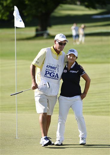 In this June 13, 2015, file photo, Sei Young Kim of South Korea hugs her caddie, Paul Fusco, on the eighteenth hole after completing the third round of the KPMG Women's PGA golf championship at the Westchester Country Club in Harrison, N.Y. The USGA says the caddie for Sei Young Kim was removed from the U.S. Women's Open for taking photos of internal notes on the course setup. Paul Fusco will not be allowed to caddie this week at Lancaster Country Club. The Women's Open starts Thursday, July 9, 2015. (AP Photo/Kathy Kmonicek, File)