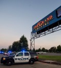 A Lafayette Police Department vehicle blocks an entrance at the Grand Theatre in Lafayette, La., following a shooting, Thursday, July 23, 2015. (Paul Kieu/The Daily Advertiser via AP)