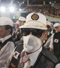 An unidentified South Korean war veteran wears a mask as a precaution against the Middle East Respiratory Syndrome (MERS) during a ceremony to mark the 65th anniversary of the outbreak of the Korean War in Seoul, South Korea, Thursday, June 25, 2015. South Korea's MERS outbreak originated from a 68-year-old man who had traveled to the Middle East, where the illness has been centered, before being diagnosed as the country's first MERS patient last month. (AP Photo/Ahn Young-joon)