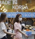 A woman wearing a mask as a precaution against Middle East Respiratory Syndrome (MERS) walks in a shopping district in Seoul, South Korea. (AP Photo/Ahn Young-joon)