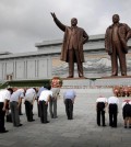 North Koreans bow in front of bronze statues of the late leaders Kim Il Sung, left, and Kim Jong Il at Munsu Hill, Monday, July 27, 2015, in Pyongyang, North Korea. North Koreans gathered to offer flowers and pay their respects to their late leaders as part of celebrations for the 62nd anniversary of the armistice that ended the Korean War. (AP Photo/Wong Maye-E)