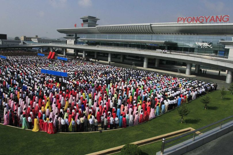 People gather during an opening ceremony of the new international airport terminal building at Pyongyang airport, Wednesday, July 1, 2015, in Pyongyang, North Korea. The unveiling Wednesday underscores an effort to attract more tourists and to spruce up the country ahead of the celebration of a major anniversary of the founding of its ruling Worker's Party in October this year. (AP Photo/Kim Kwang Hyon)