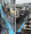 People enjoy riding a 350-meter-long waterslide on a street in Seoul's Seodamun Ward on July 19, 2015. The ward office operated the waterslide, the longest one in South Korea, in a festival aimed at helping people cool down in the summer heat. (Yonhap)