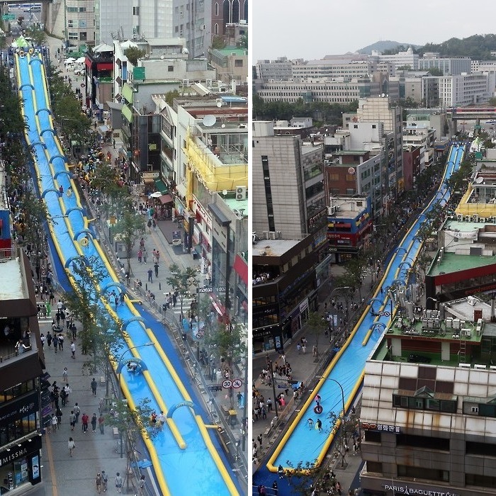 People enjoy riding a 350-meter-long waterslide on a street in Seoul's Seodamun Ward on July 19, 2015. The ward office operated the waterslide, the longest one in South Korea, in a festival aimed at helping people cool down in the summer heat. (Yonhap) 