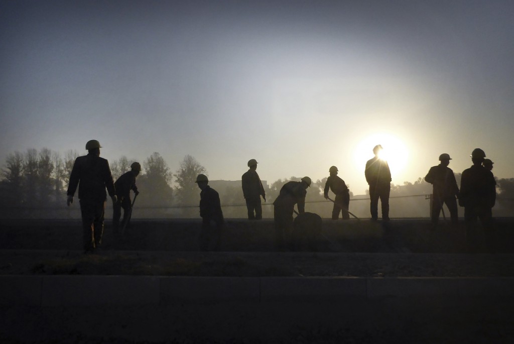 North Korean Soldiers are silhouetted against the rising sun as they work on the new building structure of the Sunan International Airport, Tuesday, Oct. 28, 2014 in Pyongyang, North Korea. The new airport, which is now in its final stages, is the latest of North Korea's "speed campaigns", mass mobilisations of labor shock brigades aimed at finishing top-priority projects in record time. (AP Photo/Wong Maye-E)