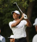 Tiger Woods watches his tee shot on the 18th hole during the first round of the Quicken Loans National golf tournament at the Robert Trent Jones Golf Club in Gainesville, Va., Thursday, July 30, 2015. (AP Photo/Steve Helber)