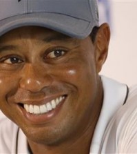 Tiger Woods smiles as he answers a question during a news conference prior to the start of the Quicken Loans National golf tournament at the Robert Trent Jones Golf Club in Gainesville, Va., Tuesday, July 28, 2015. (AP Photo/Steve Helber)