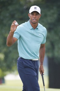 Tiger Woods tips his ball to the crowd after a birdie on the 16th hole during the first round of the Greenbrier Classic golf tournament at the Greenbrier Resort in White Sulphur Springs, W.Va., Thursday, July 2, 2015. (AP Photo/Steve Helber)