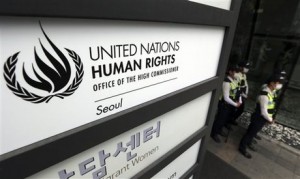 South Korean police officers stand guard by a signboard of the newly opened office of the United Nations High Commissioner for Human Rights in Seoul, South Korea, Tuesday, June 23, 2015. North Korea has scrapped plans to attend next month's University Games in South Korea to protest the opening Tuesday of the U.N. human rights office in Seoul, South Korean officials said Monday. (AP Photo/Lee Jin-man)