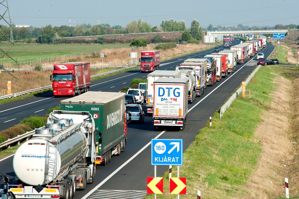 A long queue of vehicles waits on the M1 motorway near the border between Hungary and Austria near Mosonmagyarovar, 158 km northwest from Budapest, Hungary, Monday, Aug. 31, 2015. The line has reached 20 kilometers as every vehicle capable of smuggling people is checked at the border after 71 migrants were found dead in a truck Thursday. (Csaba Krizsan/MTI via AP)
