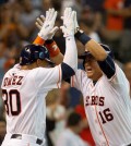 Houston Astros' Hank Conger, right, celebrates with Carlos Gomez after hitting a grand slam in the fourth inning of an MLB baseball game Saturday, Aug. 1, 2015. (Jason Fochtman/Conroe Courier via AP)