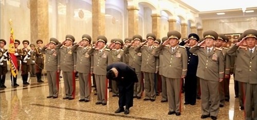 This photo captured from North Korean state television shows the country's leader, Kim Jong-un (front), and North Korean military officials paying their respects to Kim's late grandfather, Kim Il-sung, and late father, Kim Jong-il, at the Kumsusan Memorial Palace in Pyongyang on Aug. 15, 2015. (Yonhap)