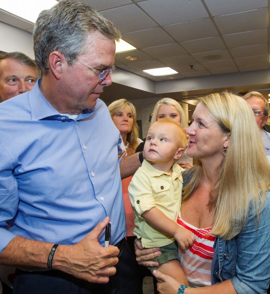 Republican presidential candidate, former Florida Gov. Jeb Bush, talks with Kate Runge and her 16-month-old son Miles, from nearby Gulf Breeze, Fla., after his town hall meeting at the Pensacola Bay Center in Pensacola, Fla., Wednesday Aug. 26, 2015. (AP Photo/Mark Wallheiser)