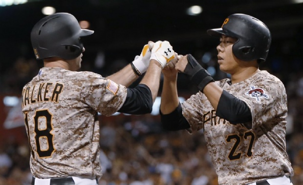 Pittsburgh Pirates' Neil Walker (18) is greeted by Jung Ho Kang after driving him in with a two-run home run during the sixth inning of a baseball game against the San Francisco Giants, Thursday, Aug. 20, 2015, in Pittsburgh. (AP Photo/Keith Srakocic)