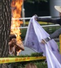 A South Korean man, left, sets himself on fire as a woman tries to extinguish him during an anti-Japan rally demanding full compensation and an apology for wartime sex slaves from the Japanese government in front of the Japanese Embassy in Seoul, South Korea, Wednesday, Aug. 12, 2015. Rescue worker Woo Kyung-suk said that the 80-year-old man sustained third-degree burns on his upper body and arms and was breathing when he was carried into an emergency vehicle. The man's motives weren't immediately clear. (AP Photo/Lee Jin-man)