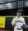 Seattle Mariners starting pitcher Hisashi Iwakuma tosses a baseball as he poses for a photo in front of the manual scoreboard at Safeco Field after he threw a no-hitter against the Baltimore Orioles in a baseball game Wednesday, Aug. 12, 2015, in Seattle. The Mariners won 3-0. (AP Photo/Ted S.)