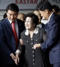 Lee Hee-ho, the widow of former South Korean President and Nobel Peace Prize laureate Kim Dae-jung, is escorted after speaking to the media at Gimpo International Airport in Seoul, South Korea, Saturday, Aug. 8, 2015, after returning from North Korea. Lee returned to Seoul after a four-day visit to North Korea that apparently ended without a meeting with North Korean leader Kim Jong Un. Lee told reporters that she wasn’t carrying any official duty on behalf of South Korea during her trip. (AP Photo/Lee Jin-man)