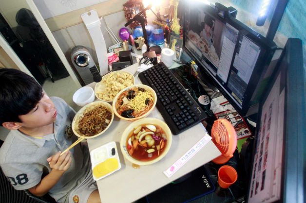 In this Monday, Aug. 17, 2015 photo, Kim Sung-jin, 14, broadcasts himself eating delivery Chinese food in his room at home in Bucheon, south of Seoul, South Korea. Every evening, he gorges on food as he chats before a live camera with hundreds, sometimes thousands, of teenagers watching. That’s the show, and it makes Kim money: 2 million won ($1,700) in his most successful episode. Better known to his viewers by the nickname Patoo, he is one of the youngest broadcasters on Afreeca TV, an app for live-broadcasting video online launched in 2006. (AP Photo/Julie Yoon)