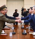 In this Aug. 22, 2015 file photo provided by the South Korean Unification Ministry, South Korean National Security Director, Kim Kwan-jin, right, and Unification Minister Hong Yong-pyo, second from right, shake hands with Hwang Pyong So, left, North Korea' top political officer for the Korean People's Army, and Kim Yang Gon, a senior North Korean official responsible for South Korean affairs, during their meeting at the border village of Panmunjom in Paju, South Korea.  (The South Korean Unification Ministry via AP)