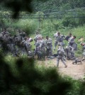 U.S Army soldiers prepare to attend a military exercise in Pocheon, south of the demilitarized zone that divides the two Koreas, South Korea, Friday, Aug. 21, 2015. North Korean leader Kim Jong Un on Friday declared his frontline troops in a "quasi-state of war" and ordered them to prepare for battle a day after the most serious confrontation between the rivals in years. ( Yonhap)