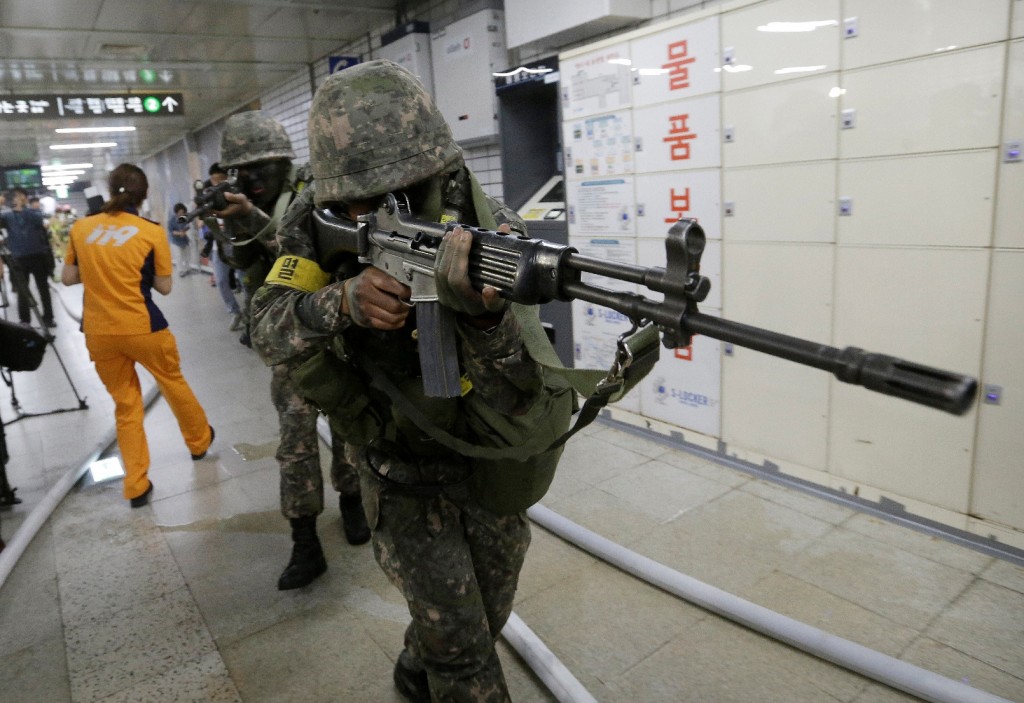 South Korean army soldiers aim their weapons during an anti-terror drill as part of Ulchi Freedom Guardian exercise, at Sadang Subway Station in Seoul, South Korea, Wednesday, Aug. 19, 2015. U.S. and South Korean forces launched Monday an annual joint military exercises, Ulchi Freedom Guardian, for a 12-day run to prepare for a possible North Korea's attack. (AP Photo/Ahn Young-joon)